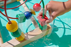 Baby, child playing in nursery. Happy healthy child having fun with colorful toy at home.Colorful toy labyrinth