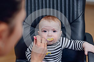 Adorable Baby on Chair Eating Porridge Food