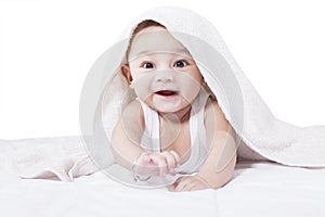 Adorable baby crawling on bed