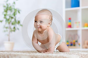 Adorable baby crawling on floor in the nursery