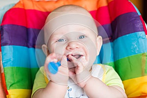 Adorable baby eating in high chair