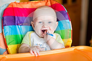 Adorable baby eating in high chair