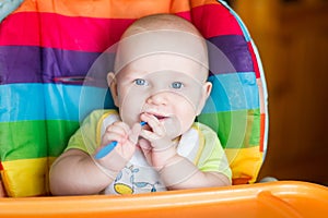 Adorable baby eating in high chair