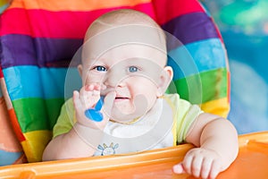 Adorable baby eating in high chair