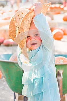 Adorable Baby Girl with Cowboy Hat in a Country Rustic Setting at the Pumpkin Patch