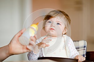 Adorable baby girl drinking formula milk from bottle. food, child, feeding and people concept -cute toddler, daughter