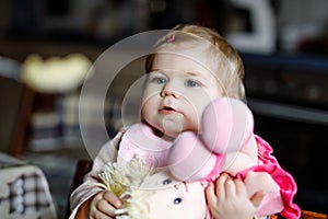 Adorable baby girl eating from spoon mashed vegetables and puree. food, child, feeding and people concept -cute toddler