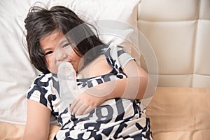 Adorable baby girl holding milk bottle and drinking