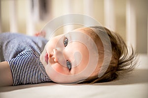 Adorable Baby Girl Lays in Crib