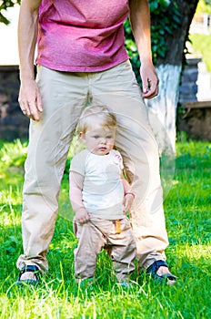 Adorable baby girl making first steps