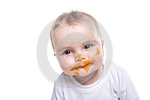 Adorable baby girl making a mess while feeding