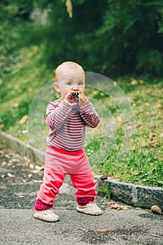 Adorable baby girl playing outside