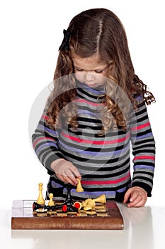 Adorable baby girl playing chess