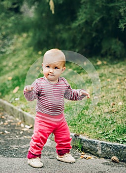 Adorable baby girl playing outside