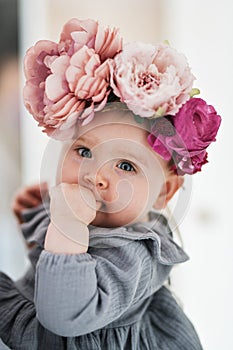 Adorable baby girl with wearing wreath.