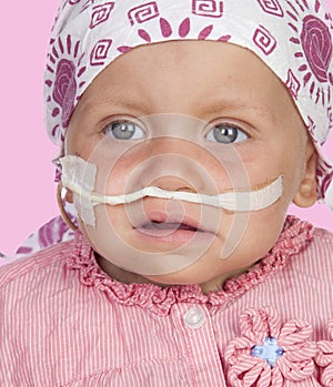 Adorable baby with a headscarf beating the disease