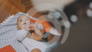 Adorable baby holding father hand. Mulatto baby playing with fathers hand. close up