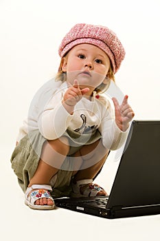 Adorable baby with laptop