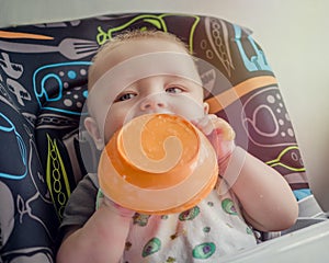 Adorable baby learning to feed himself for the first time