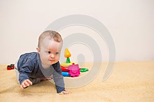 Adorable baby playing with educational toys . background with copy space. Happy healthy child having fun at home