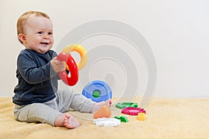 Adorable baby playing with educational toys . background with copy space. Happy healthy child having fun at home. Early