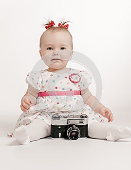 Adorable baby with retro camera