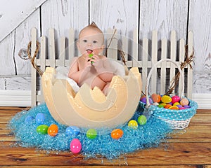 Adorable baby sitting in giant easter egg