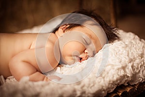 Adorable baby sleeping on stomach. Studio shot.