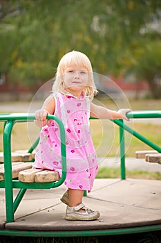 Adorable baby spinnning on carousel