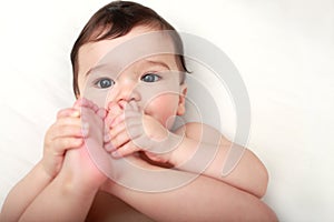 Adorable baby sucking his toes