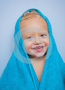 Adorable baby under a hooded towel after bath. Bubble Bath time. Happy bath time.