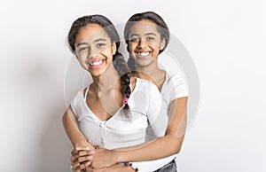 Adorable black twin teen girl on studio white background