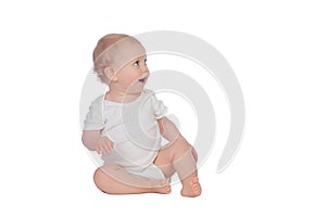 Adorable blond baby sitting on the floor