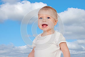 Adorable blond baby with two small teeth