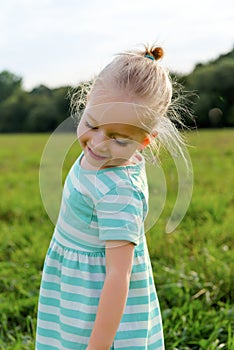 Adorable blond little girl with cheeky smile
