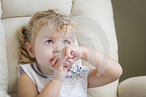 Adorable Blonde Haired and Blue Eyed Little Girl in Chair