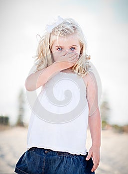 Adorable Blue Eyed Girl Covering Her Mouth