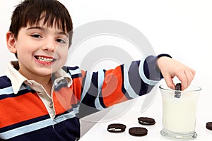 Adorable Boy Dunking Cookies in Milk