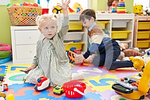 Adorable boy and girl playing supermarket game and with car toys at kindergarten