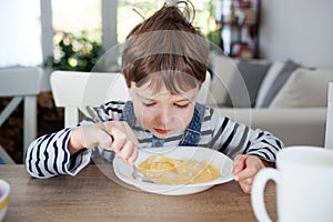 Adorable boy having a breakfast