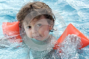 Adorable boy learning to swim