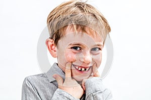 Adorable boy playing with a fake toothless smile, isolated portrait