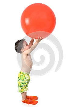 Adorable Boy Ready To In Swim Gear With Giant Orange Ball Over W