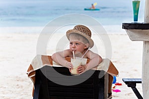 Adorable boy sipping milkshake