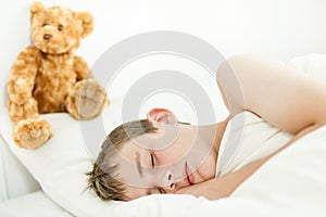 Adorable boy sleeping with plush bear