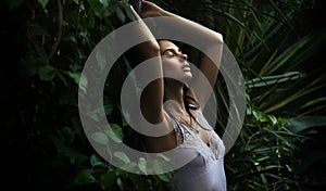 Adorable brunette in a rain forest