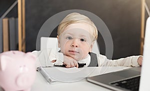 Adorable business baby boy working at office