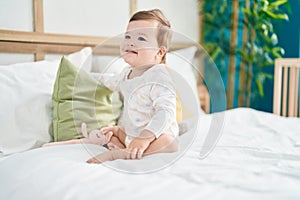 Adorable caucasian baby smiling confident sitting on bed at bedroom