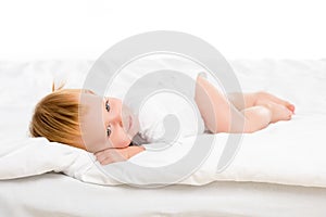 adorable caucasian babyin bodysuit lying