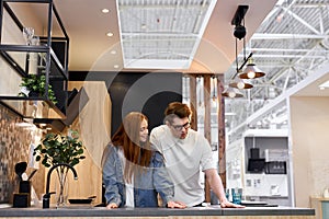 Adorable caucasian couple came to choose interior for future kitchen